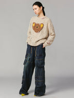 Teddy bear peeking through sweater
