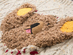 Teddy bear peeking through sweater