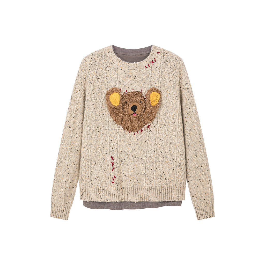 Teddy bear peeking through sweater