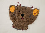 Teddy bear peeking through long-sleeve T-shirt