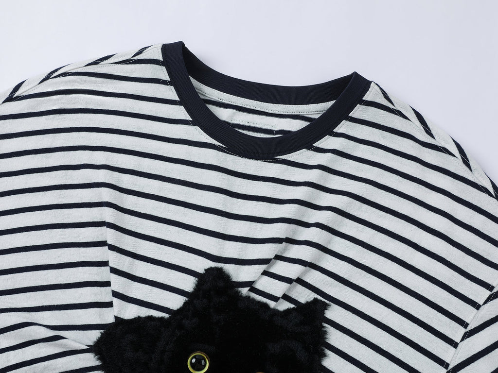 Playful cat scratching bedsheet striped T-shirt