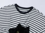 Playful cat scratching bedsheet striped T-shirt