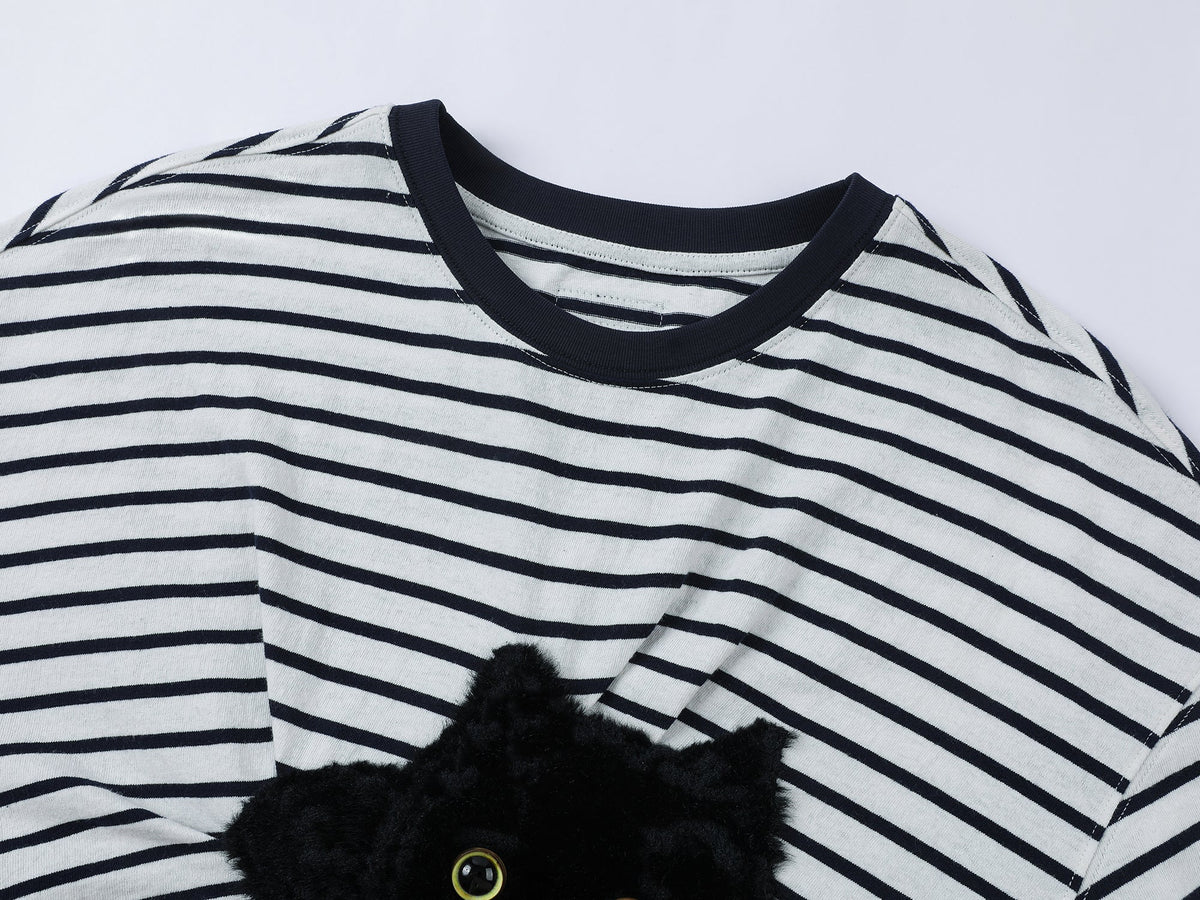 Playful cat scratching bedsheet striped T-shirt