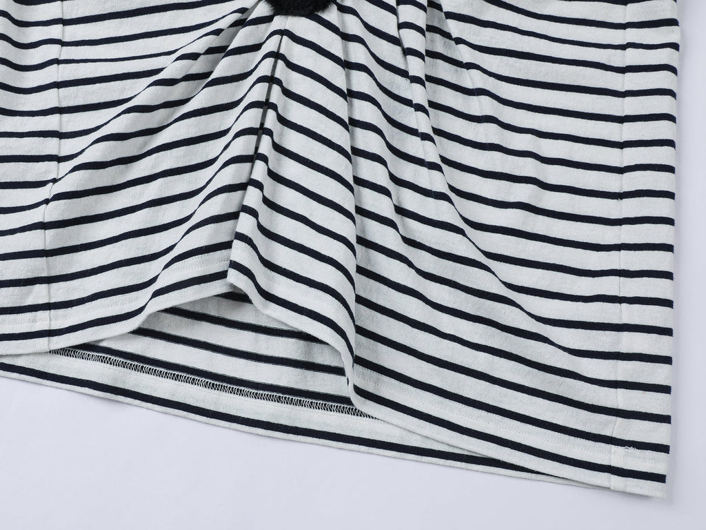 Playful cat scratching bedsheet striped T-shirt