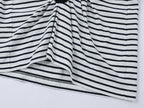 Playful cat scratching bedsheet striped T-shirt