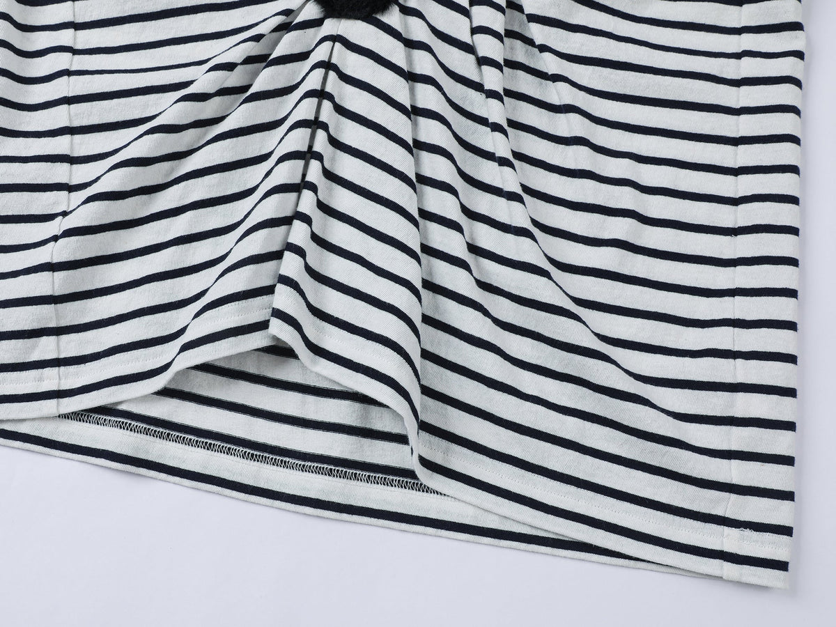 Playful cat scratching bedsheet striped T-shirt