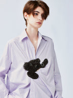 Playful puppy biting shirt