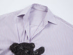 Playful puppy biting shirt