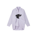Playful puppy biting shirt