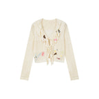 Handcrafted patch cardigan with ruffled edges