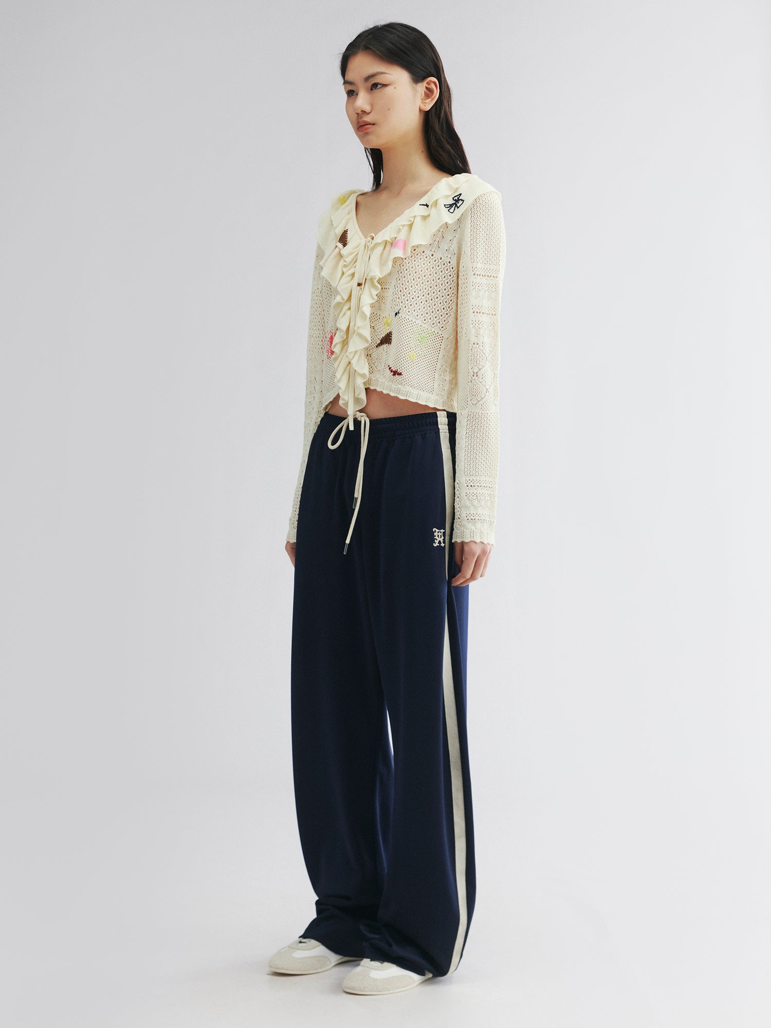 Handcrafted patch cardigan with ruffled edges