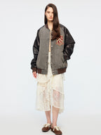 Baseball jacket with leather sleeves and badges