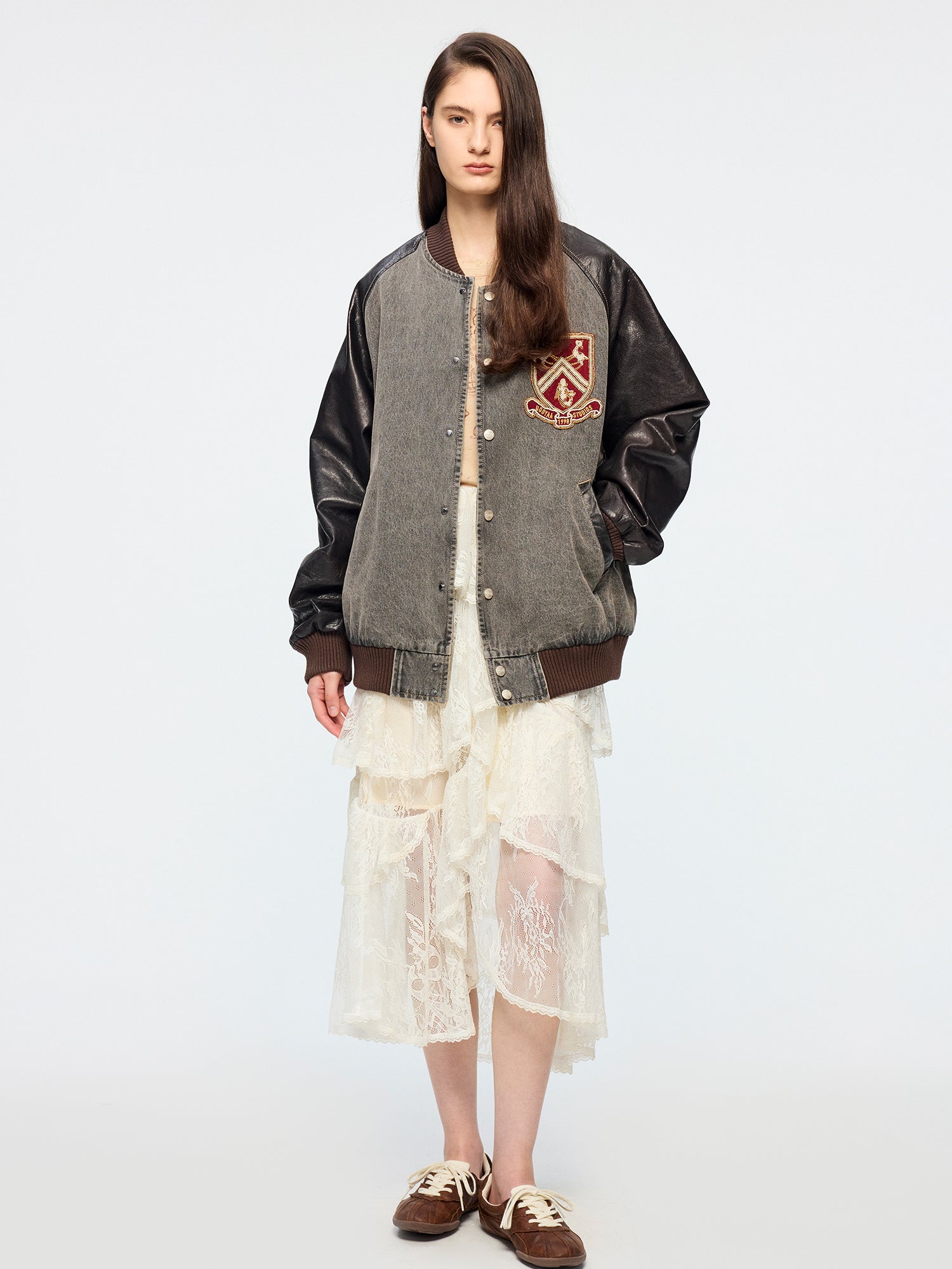 Baseball jacket with leather sleeves and badges