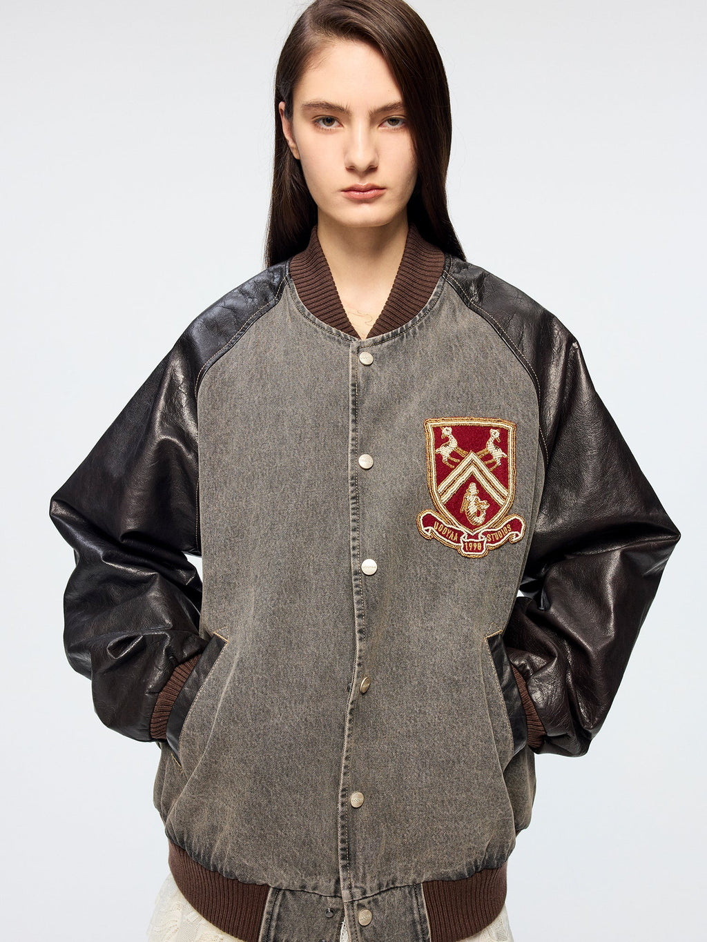 Baseball jacket with leather sleeves and badges