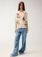 Hand-crocheted insect and floral tie-front polo knit shirt