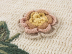 Hand-crocheted insect and floral cardigan