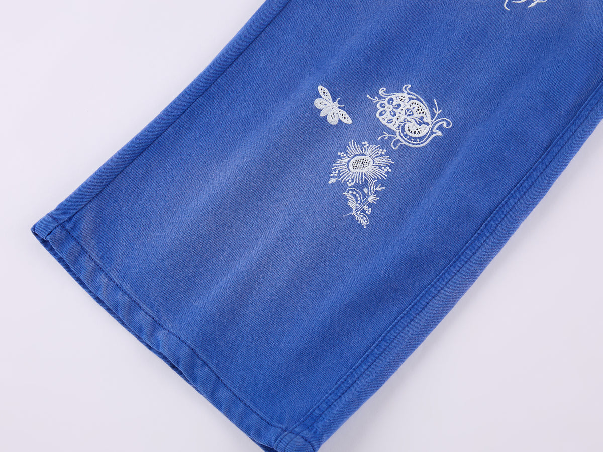 Lace insect and floral motif curved denim pants