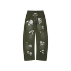 Lace insect and floral motif curved denim pants